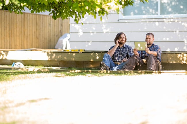 Contractors at work site contacting a business and corporate lawyer in the south Edmonton law office of Coley Hennessy Cassis for legal help to incorporate their business